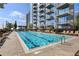 Luxury building swimming pool with lounge chairs at 855 Peachtree Ne St # 3005, Atlanta, GA 30308