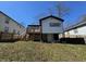 View of the back exterior featuring a wooden deck, basement access, and nice yard at 880 Westmont Sw Rd, Atlanta, GA 30311