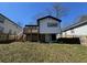 View of the back exterior featuring a wooden deck, basement access, and nice yard at 880 Westmont Sw Rd, Atlanta, GA 30311