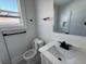 Bright bathroom with modern fixtures, marble-look countertop, and sleek black hardware at 880 Westmont Sw Rd, Atlanta, GA 30311