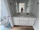 Bathroom featuring double sink vanity with white cabinets and marble countertop at 880 Westmont Sw Rd, Atlanta, GA 30311