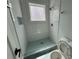 Updated bathroom featuring tiled shower, new toilet and a window at 880 Westmont Sw Rd, Atlanta, GA 30311
