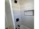 Bathroom with bathtub featuring tiled walls, black showerhead, and niche at 880 Westmont Sw Rd, Atlanta, GA 30311
