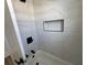 Bathroom with bathtub featuring tiled walls, black showerhead, and niche at 880 Westmont Sw Rd, Atlanta, GA 30311