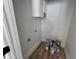Laundry room with white upper cabinets, wood-look flooring, and washer hookups at 880 Westmont Sw Rd, Atlanta, GA 30311