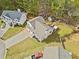 Aerial view of a home with a spacious backyard featuring a deck, surrounded by mature trees and landscaping at 3638 Clubside Nw Walk, Kennesaw, GA 30144