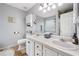 Bright bathroom featuring dual sinks, ample vanity space, and a separate toilet room, creating a functional design at 3638 Clubside Nw Walk, Kennesaw, GA 30144