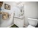 Cozy bathroom featuring a vanity with sink, toilet, and towel racks for convenience at 3638 Clubside Nw Walk, Kennesaw, GA 30144