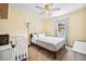 Sunny bedroom showcasing a bed, crib, neutral tones, and bright natural light at 3638 Clubside Nw Walk, Kennesaw, GA 30144