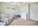Cozy carpeted room featuring a gray accent chair and playful decor, creating an inviting space for children at 3638 Clubside Nw Walk, Kennesaw, GA 30144