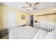 Well-lit bedroom featuring a ceiling fan, and white wood trim, complemented by an adjacent desk and white baby crib at 3638 Clubside Nw Walk, Kennesaw, GA 30144