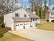 Well-maintained home with a stone-accented garage, charming front porch, and a spacious driveway at 3638 Clubside Nw Walk, Kennesaw, GA 30144
