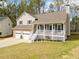 Attractive home boasts a quaint front porch, neat landscaping, and a convenient two-car garage at 3638 Clubside Nw Walk, Kennesaw, GA 30144