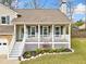 Inviting home featuring a cozy front porch with white railings and a beautifully landscaped garden at 3638 Clubside Nw Walk, Kennesaw, GA 30144
