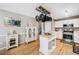 Cozy kitchen featuring wood floors, white cabinets, stainless steel appliances, and decorative island at 3638 Clubside Nw Walk, Kennesaw, GA 30144