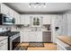 Stylish kitchen featuring stainless steel appliances, white cabinetry, and hardwood floors at 3638 Clubside Nw Walk, Kennesaw, GA 30144