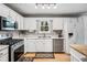 Modern kitchen showcasing stainless steel appliances, white cabinets, and hardwood floors at 3638 Clubside Nw Walk, Kennesaw, GA 30144