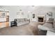 Bright living room with fireplace, neutral carpet and paint, and open view to kitchen at 3638 Clubside Nw Walk, Kennesaw, GA 30144