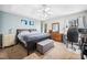 Inviting main bedroom with a tray ceiling, complemented by a bench, dresser, and a dedicated computer workspace at 3638 Clubside Nw Walk, Kennesaw, GA 30144