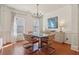 Well-lit dining room featuring a glass table, contemporary chandelier and wainscoting at 5890 Vinyard Ln, Cumming, GA 30041
