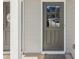 Close up view of the gray front door with glass inserts at 5890 Vinyard Ln, Cumming, GA 30041