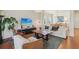 Bright living room features a large sofa, modern furniture, and views of the dining area at 5890 Vinyard Ln, Cumming, GA 30041