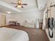 Spacious main bedroom boasts tray ceiling, fan, neutral colors, and space for work/sitting area at 5890 Vinyard Ln, Cumming, GA 30041