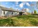 Large grassy backyard with back of house and tree coverage at 603 Bluff Dr, Woodstock, GA 30188