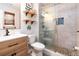 Bathroom featuring a glass shower, vanity, mirror and wall shelving at 603 Bluff Dr, Woodstock, GA 30188