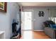 Entryway with a decorative Remillard sign, coat rack, and natural light coming through the open front door at 603 Bluff Dr, Woodstock, GA 30188