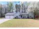 Charming one-story home with a two-car garage and a well-manicured lawn, showcasing its inviting curb appeal at 603 Bluff Dr, Woodstock, GA 30188