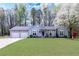 Charming one-story home with a two-car garage and a well-manicured lawn, showcasing its inviting curb appeal at 603 Bluff Dr, Woodstock, GA 30188