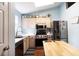 Bright kitchen featuring stainless steel appliances, a wooden island, and a light blue color scheme at 603 Bluff Dr, Woodstock, GA 30188
