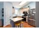 Bright kitchen with stainless steel appliances, butcher block island and ample counter space, perfect for cooking at 603 Bluff Dr, Woodstock, GA 30188