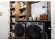Laundry room showcases a side-by-side washer and dryer set with wood shelving at 603 Bluff Dr, Woodstock, GA 30188