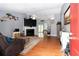 Inviting living room featuring hardwood floors, a cozy fireplace, and a large screen TV at 603 Bluff Dr, Woodstock, GA 30188