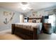 Bedroom features natural light, coastal decor, a dark wood bed, and a ceiling fan at 603 Bluff Dr, Woodstock, GA 30188