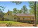 Rear exterior view of the home featuring a deck, well-maintained yard, and natural landscaping at 270 Albertas Ct, Mcdonough, GA 30252