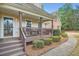 Inviting front porch with rocking chairs, a well-maintained garden, and a welcoming entrance at 270 Albertas Ct, Mcdonough, GA 30252