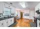 Bright kitchen featuring white cabinets, black countertops, stainless steel appliances and hardwood floors at 270 Albertas Ct, Mcdonough, GA 30252