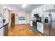 A bright kitchen features stainless appliances, white cabinetry, and black countertops at 270 Albertas Ct, Mcdonough, GA 30252