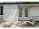 Back entrance with white painted brick and glass paneled doors, leading to the patio at 3501 Wesley Chapel Rd, Decatur, GA 30034