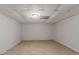 View of the unfinished basement with tile floors, white walls and drop ceiling, offering potential for customization at 3501 Wesley Chapel Rd, Decatur, GA 30034