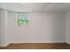 Unfinished basement with a window, white walls, and wood-look floors at 3501 Wesley Chapel Rd, Decatur, GA 30034