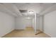 Finished basement with support beam. Stairs can be seen leading to main floor at 3501 Wesley Chapel Rd, Decatur, GA 30034