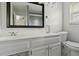 Well-lit bathroom with a vanity, toilet, and framed mirror at 3501 Wesley Chapel Rd, Decatur, GA 30034