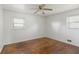 Bedroom with hardwood floors, two windows, and ceiling fan at 3501 Wesley Chapel Rd, Decatur, GA 30034