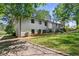 Two story home with white painted brick, black trim, with a large front yard at 3501 Wesley Chapel Rd, Decatur, GA 30034