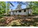 Exterior elevation shows a home with white painted brick and mature trees in the backyard at 3501 Wesley Chapel Rd, Decatur, GA 30034