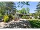 Attractive home exterior with mature landscaping and a curved driveway at 3501 Wesley Chapel Rd, Decatur, GA 30034